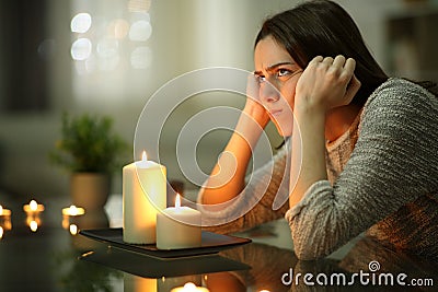 Angry homeowner using candles during power outage Stock Photo