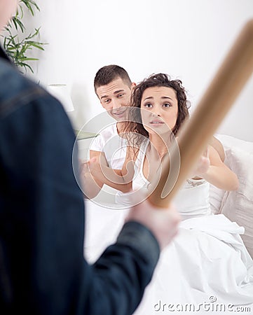 Angry husband with baseball bat caught cheating wife with lover Stock Photo