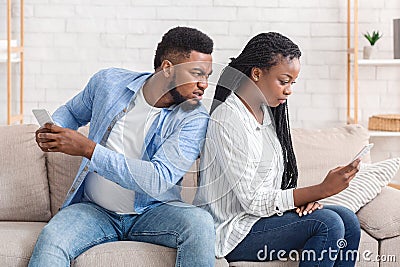 Angry Husband Catching Cheating Wife Texting On Cellphone With Another Man Stock Photo