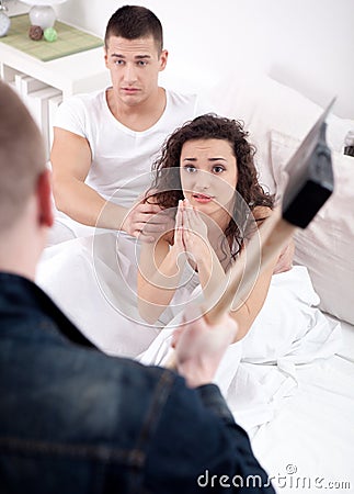 Angry husband with hatchet caught cheating wife with lover Stock Photo