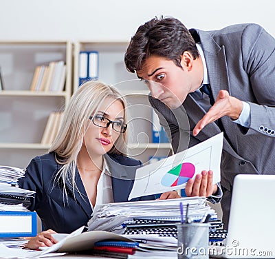 Angry irate boss yelling and shouting at his secretary employee Stock Photo