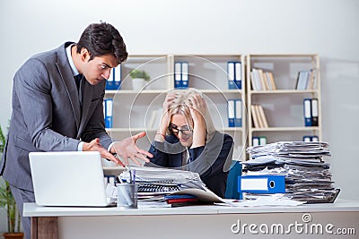 The angry irate boss yelling and shouting at his secretary employee Stock Photo
