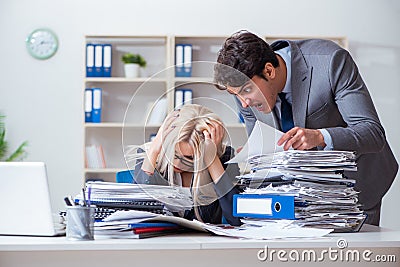 The angry irate boss yelling and shouting at his secretary employee Stock Photo