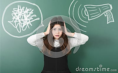 Angry and irritated teenage girl closes her ears from megaphone Stock Photo