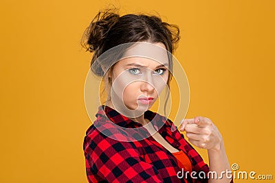 Angry irritated young woman in plaid shirt pointing on you Stock Photo