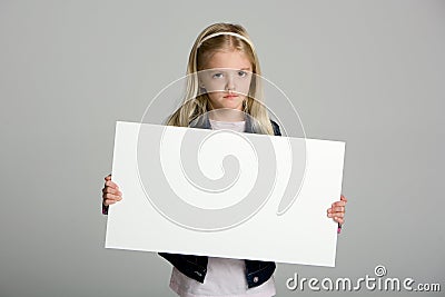 Angry little girl holding a blank sign Stock Photo