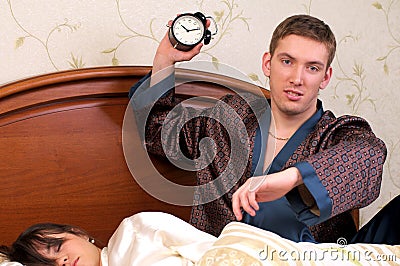 Angry man with alarm clock Stock Photo