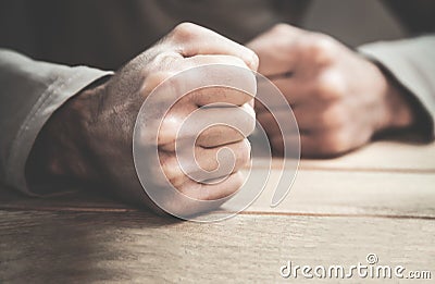 Angry man fists in the table. Stock Photo