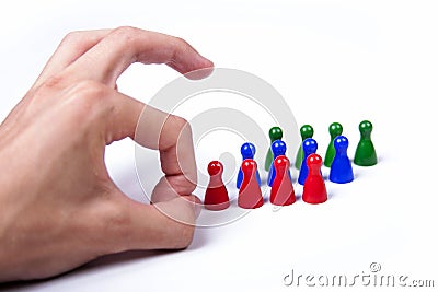 Angry man flicks small colorful game pieces, flicking gesture, bad leader concept Stock Photo