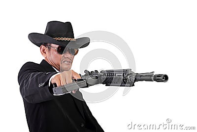 Angry mobster firing his gun maniacally Stock Photo