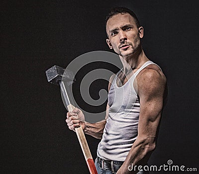 Angry muscular man with hammer Stock Photo