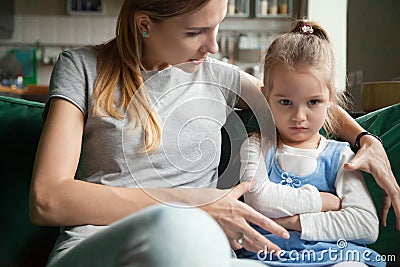 Angry offended little girl ignoring mother words, advice Stock Photo