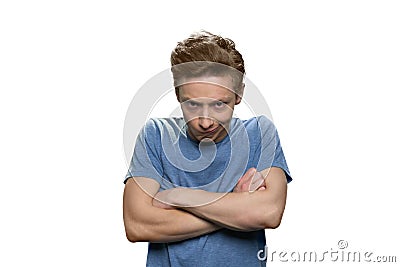 Angry offended young guy with his arms folded. Stock Photo