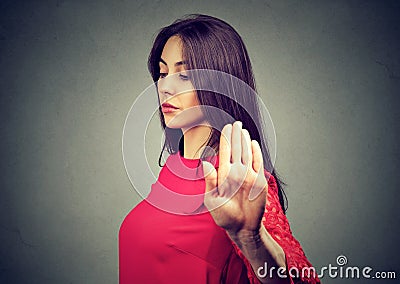 Angry offended young woman giving talk to hand gesture Stock Photo