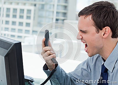 Angry office worker on the phone Stock Photo