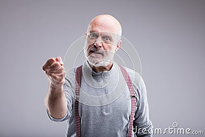 Aged angry man threatin with a punch Stock Photo
