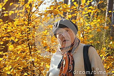 Angry old woman feels the outrage in autumn park Stock Photo