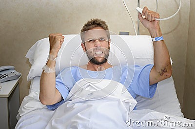 Angry patient man at hospital room lying in bed pressing nurse call button feeling nervous and upset Stock Photo