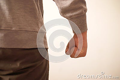 Angry person conceptual, clasped hands close up, ready to fight or punch, anonymous Stock Photo