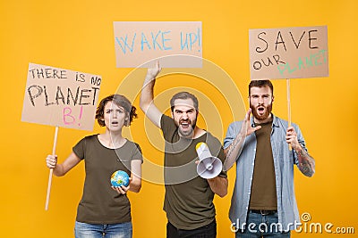 Angry protesting people hold protest signs broadsheet placard world globe scream in megaphone isolated on yellow Stock Photo