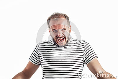 Angry screaming bearded adult rage man in a striped T-shirt. 30-35 years old. Isolated on white Stock Photo