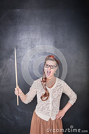 Angry screaming teacher with pointer on the chalkboard background Stock Photo