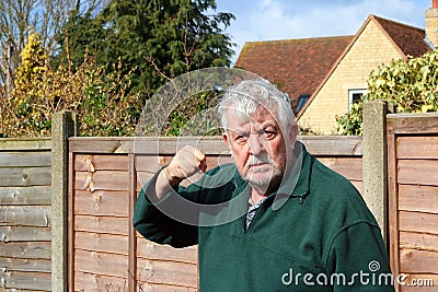 Angry senior man raised fist. Ready to punch. Stock Photo