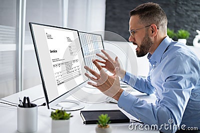 Angry Tax Accountant Reading Electronic Invoice Stock Photo