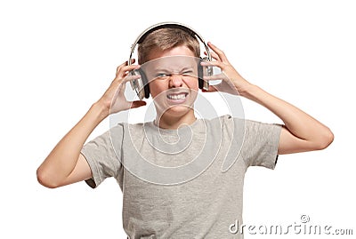 Angry teenage boy takes off headphones Stock Photo