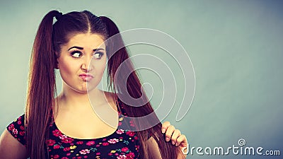 Angry teenager girl with brown hair ponytails Stock Photo