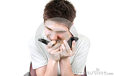 Angry teenager with two phones Stock Photo