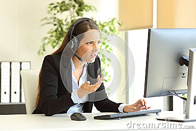 Angry tele marketer attending customer at office Stock Photo