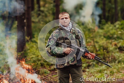 Angry terrorist militant guerrilla soldier warrior in forest Stock Photo