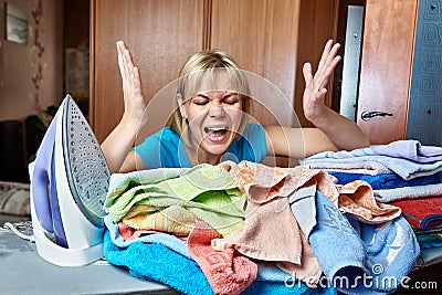 Angry and tired woman housewife from ironing board Stock Photo