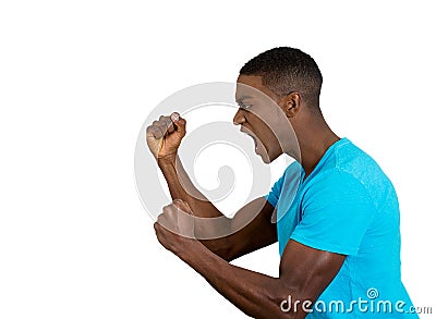 Angry upset young man, employee, fists in air, open mouth yelling Stock Photo