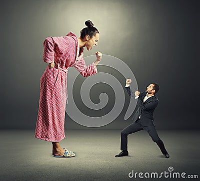 Angry wife and small henpecked husband Stock Photo