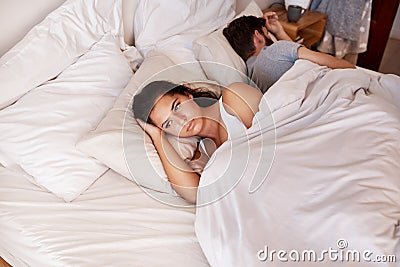 Angry woman, couple and fight in bed in the morning feeling frustrated from divorce talk. Marriage problem, conflict and Stock Photo