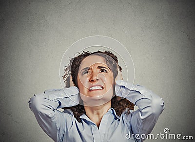 Angry woman covering ears looking up stop loud noise Stock Photo