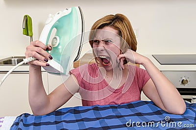 Angry woman or crazy busy housewife ironing shirt lazy at home k Stock Photo