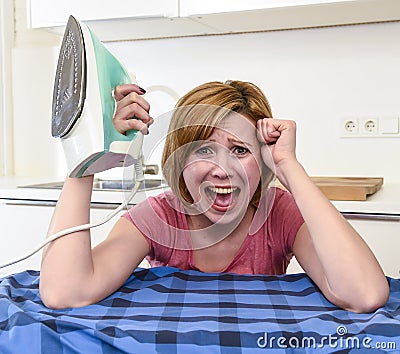 Angry woman or crazy busy housewife ironing shirt lazy at home k Stock Photo