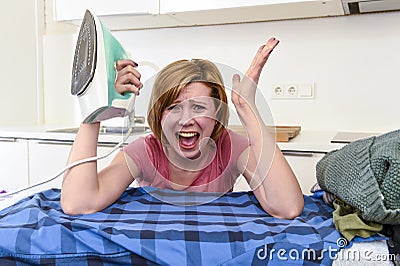 Angry woman or crazy busy housewife ironing shirt lazy at home k Stock Photo