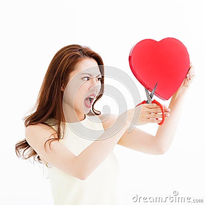 Angry woman cutting the heart shape by scissors Stock Photo