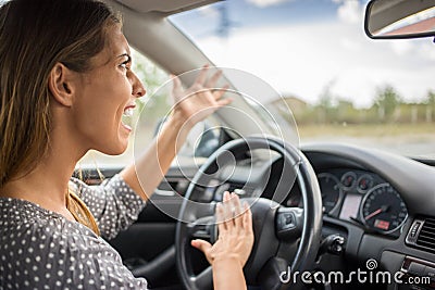 Angry woman honking in the car Stock Photo