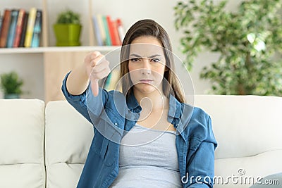Angry woman looking at camera with thumbs down Stock Photo