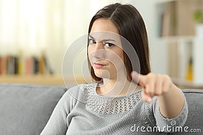 Angry woman pointing at camera at home Stock Photo