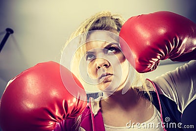 Angry woman wearing boxing gloves Stock Photo