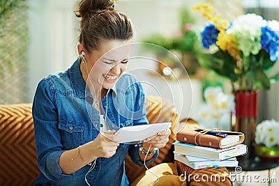 Angry woman with white headphones and tablet PC study online Stock Photo