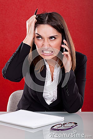 Angry woman at work Stock Photo