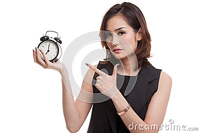 Angry young Asian woman point to a clock. Stock Photo