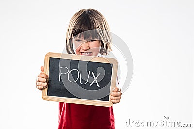 Angry young child rejecting head lice from a school slate Stock Photo